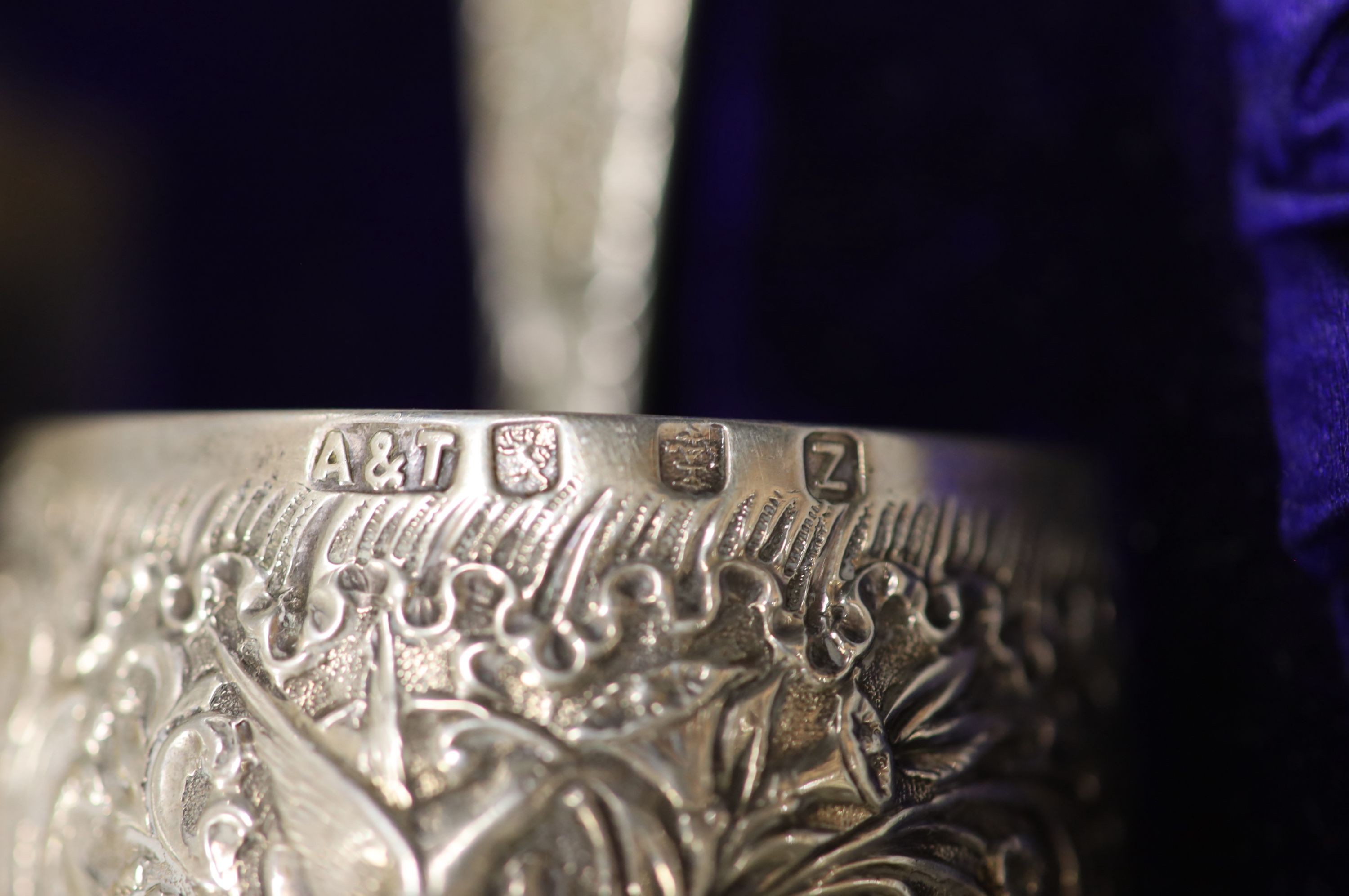 A cased late Victorian embossed silver christening bowl, spoon and napkin ring, Aird & Thomson, Glasgow, 1896, bowl 10.7cm, 7.5oz.